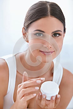 Face Skin Care. Beautiful Woman With Facial Cream. Cosmetics