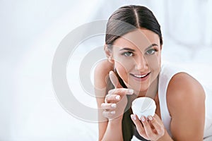 Face Skin Care. Beautiful Woman With Facial Cream. Cosmetics