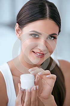 Face Skin Care. Beautiful Woman With Facial Cream. Cosmetics