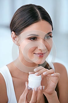 Face Skin Care. Beautiful Woman With Facial Cream. Cosmetics