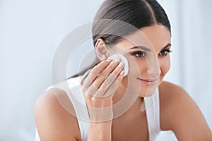 Face Skin Care. Beautiful Woman Removing Makeup With Cotton Pad