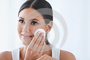 Face Skin Care. Beautiful Woman Removing Makeup With Cotton Pad