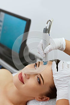 Face Skin Care. Closeup Of Woman Face Cleansing At Cosmetology