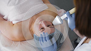 Face skin care treatment. Ultrasound cavitation anti-aging, rejuvenation, lifting procedure in medical cosmetology spa