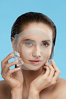 Face Skin Care. Woman Applying Ice Cubes