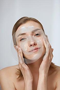 Face skin care. Woman cleaning facial skin with foam soap