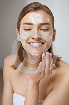 Face skin care. Woman cleaning facial skin with foam soap