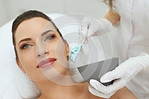 Face Skin Care. Woman Doing Alginate Facial Mask At Cosmetology