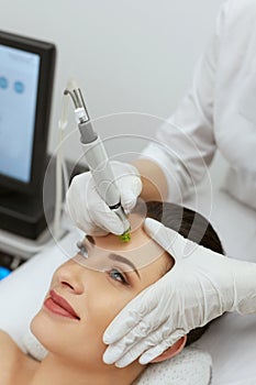 Face Skin Care. Woman Getting Facial Hydro Exfoliating Treatment