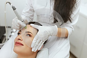 Face Skin Care. Woman Getting Facial Hydro Exfoliating Treatment