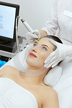 Face Skin Care. Woman Getting Facial Hydro Exfoliating Treatment photo