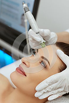 Face Skin Care. Woman Getting Facial Hydro Exfoliating Treatment photo