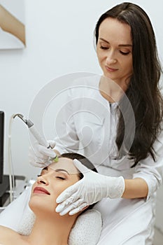 Face Skin Care. Woman Getting Facial Hydro Exfoliating Treatment photo