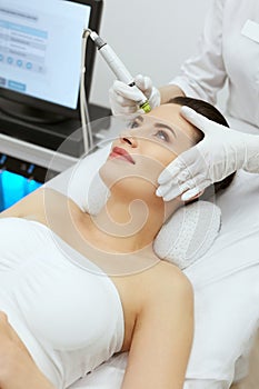 Face Skin Care. Woman Getting Facial Hydro Exfoliating Treatment photo
