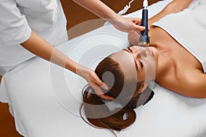 Face skin care. Woman lies on a table in a beauty spa getting a
