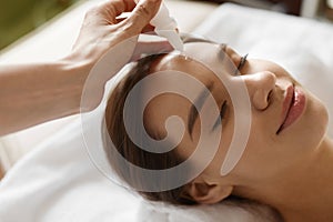 Face Skin Care. Woman Receiving Serum Treatment In Beauty Salon