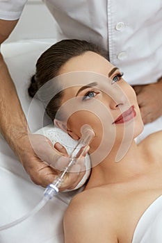 Face Skin Cleaning At Beauty Clinic. Woman Gets Vacuum Treatment