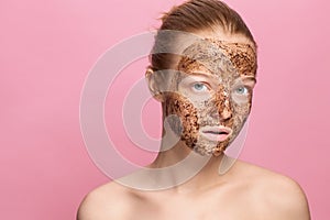 Face Skin Scrub. Portrait Of Smiling Female Model Applying Natural Coffee Mask, Face Scrub On Facial Skin. Closeup