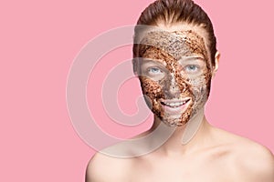 Face Skin Scrub. Portrait Of Smiling Female Model Applying Natural Coffee Mask, Face Scrub On Facial Skin. Closeup