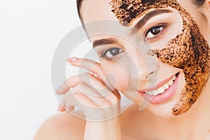 Face Skin Scrub. Smiling Girl Applying Coffee Mask Scrub On Skin