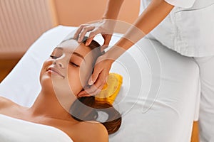 Face skin. Woman receiving facial spa treatment, massage.