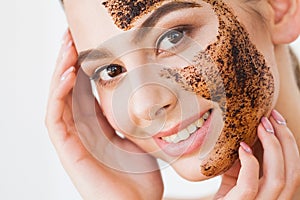 Face Skincare. Young charming girl makes a black charcoal mask o