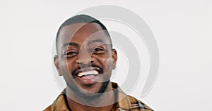 Face, smile and funny with a black man closeup in studio on a white background for comedy or humor. Portrait, happy