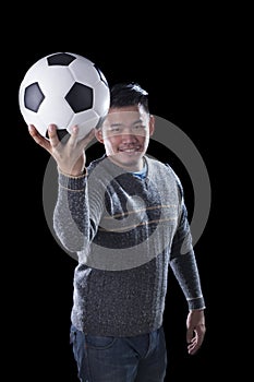 face of soccer lover holding football ball isolated black background use for sport and people activities theme