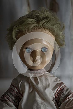 Face of spooky old abandoned doll