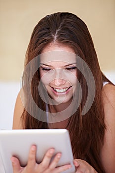 Face, tablet and social media with a woman in the bedroom of her home to relax while browsing the internet. Smile