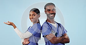 Face, teamwork and doctors with show, space and announcement on a blue studio background. Portrait, man and woman with