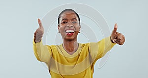 Face, thumbs up and dance with a black woman in studio on a blue background for motivation or success. Portrait, smile