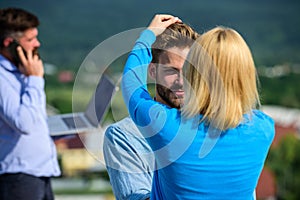 Face to face conversation advantages concept. Couple having fun while busy businessman speak on phone. Couple happy