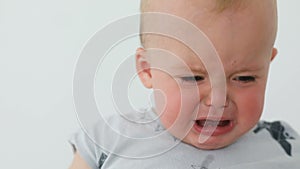 Face of unhappy baby crying