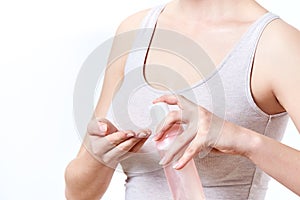 Face washing concept isolated on white background. Unrecognisable woman holding bottle of foaming cleanser. photo