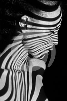 The face of woman with black and white zebra