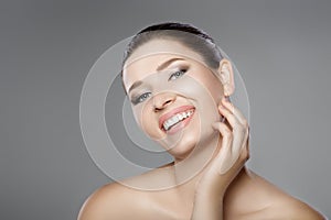 Face of woman with blue eyes and clean fresh skin. Beautiful smile and white teeth