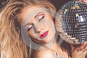 Face of woman with disco ball