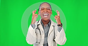 Face, woman and doctor with fingers crossed, green screen and healthcare with happiness, hope and luck. Portrait, female