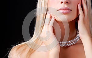 Face of woman and pearl necklace