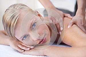 Face, woman in portrait getting back massage at spa and holistic treatment with self care. Wellness, young female at