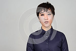 Face of young androgynous Asian transgender woman