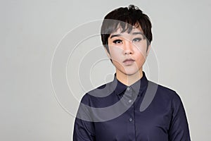 Face of young androgynous Asian transgender woman photo