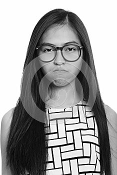 Face of young Asian teenage nerd girl looking upset