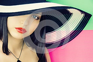 Face of young beautiful brunette in hat