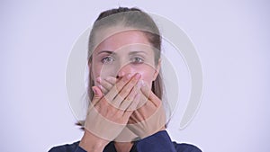 Face of young beautiful businesswoman showing speak no evil concept