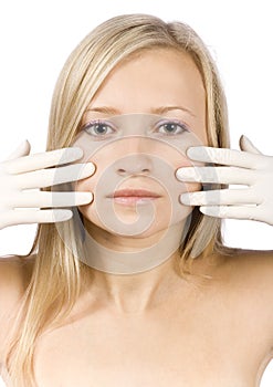 Face of young blonde woman + her hands in gloves