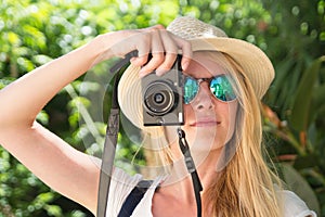 face young blonde woman photographer taking photo with camera