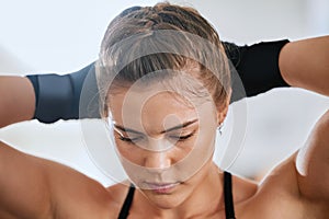 Face of a young female boxer getting ready to train in the gym for a boxing match. Sporty, active and healthy athlete