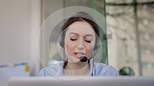 Face Of Young Girl. She Is In Headphones And With Microphone. She Is Talking. Employee Of The Call Center.
